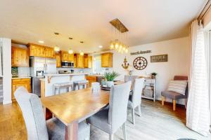 a kitchen and dining room with a wooden table and chairs at Dory Pointe Dream in Pacific City