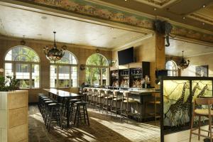 a restaurant with a bar with stools at The Davenport Tower, Autograph Collection in Spokane