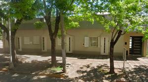 a building with trees in front of it at Apart Hotel RioSol - Monoambientes in Concepción del Uruguay
