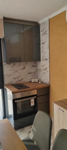 a kitchen with a stove and a counter top at Тера Лакшъри Суит in Asenovgrad +5 photos