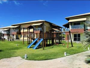 a playground in front of a apartment building at Village Baixio Garden in Baixio
