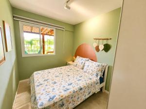 a small bedroom with a bed and a window at Village Baixio Garden in Baixio +19 photos