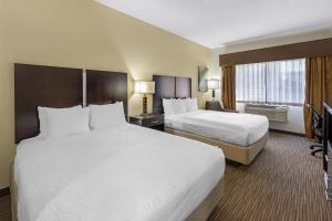 a hotel room with two beds and a television at Best Western Plus the Four Corners Inn in Farmington +40 photos
