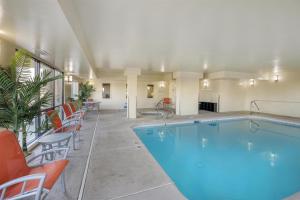 a pool in a hotel room with chairs around it at Best Western Plus the Four Corners Inn in Farmington