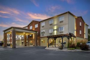 a rendering of a building with a parking lot at Best Western Plus the Four Corners Inn in Farmington