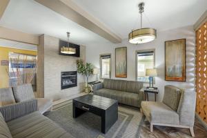 a living room with a couch and a table at Best Western Plus the Four Corners Inn in Farmington