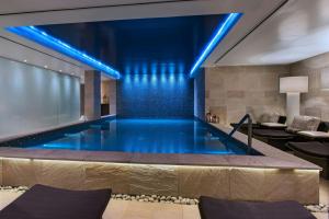a swimming pool in a hotel with blue lights at JW Marriott El Convento Cusco in Cusco