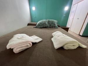 a bed with two towels on top of it at Apart Hotel RioSol - Monoambientes in Concepción del Uruguay +31 photos