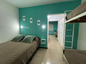 a bedroom with a bed and a bunk bed at Apart Hotel RioSol - Monoambientes in Concepción del Uruguay