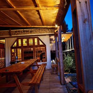 a wooden deck with a wooden table and benches at Wood & Net in Iringa