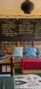 a room with two beds and a wall with writing on it at Wood & Net in Iringa +49 photos
