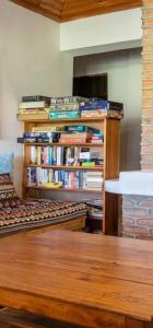 a room with a book shelf filled with books at Wood & Net in Iringa