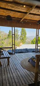 a bedroom with a bed on a wooden deck at Wood & Net in Iringa