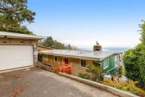 a house with a garage in front of it at The Nook on Chinook in Tillamook