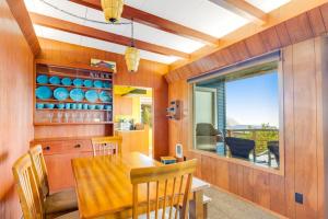 a dining room with a wooden table and a window at The Nook on Chinook in Tillamook