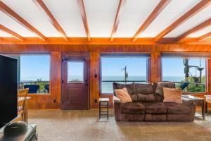 a living room with a couch and a view of the ocean at The Nook on Chinook in Tillamook
