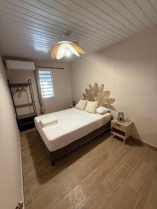 a bedroom with a large bed in a room at Villa R-A in Kourou