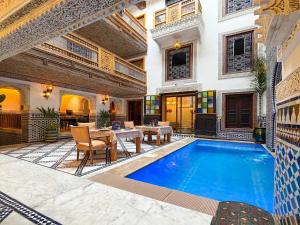 a villa with a swimming pool and a patio at Riad Dar ElBellar in Fez