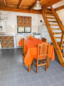 a kitchen with an orange table and chairs at Miniloft Centrico in El Calafate