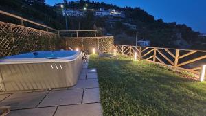 a bath tub sitting on the grass in a yard at Otium Relais in Furore