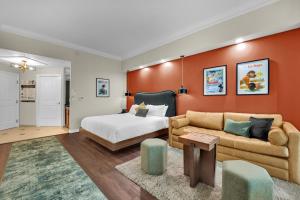 a bedroom with a bed and a couch at Luma Vera Penthouse Sanctuary Strip Views in Las Vegas