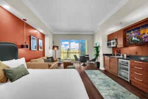 a bedroom with a large bed and a living room at Luma Vera Penthouse Sanctuary Strip Views in Las Vegas