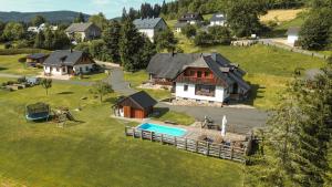 an aerial view of a house with a playground at Penzion U Andresů in Zadov
