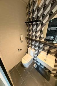 a bathroom with a toilet and a sink at GoStay Pods at Perak Road in Singapore