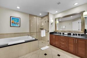 a bathroom with a tub and a shower and a sink at Luma Vera Penthouse Sanctuary Strip Views in Las Vegas +20 photos