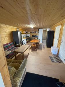 a living room with a couch and a table at Room 2 in Hästveda