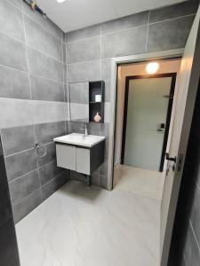 a bathroom with a sink and a mirror and a door at Studio Filo in Liège