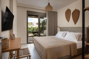 a hotel room with a bed and a balcony at DARION Residence in Nikiti