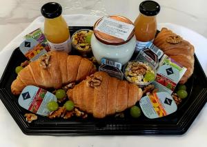 a tray of food with bread and drinks on a table at Sweethome12 in Fonyód