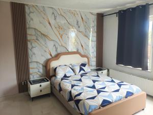 a bedroom with a bed with a mural on the wall at Studio Filo in Liège
