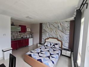a bedroom with a bed in front of a wall at Studio Filo in Liège