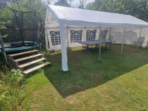 a tent with a ping pong table in a yard at Haby House in Skene
