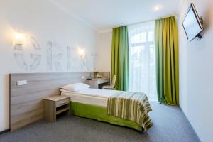 a hotel room with a bed and a window at PracticOtel Kyiv in Kyiv