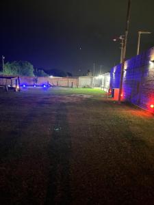 a soccer field at night with blue and red lights at El triángulo finca familiar in Maco