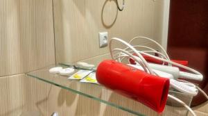 a red blow dryer on a glass table in front of a mirror at ASINE Dilijan in Dilijan +73 photos