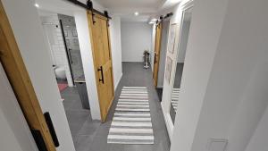 a hallway with a row of doors and striped floors at Orscholz apt with free parking & garden & bicycle storage in Orscholz +10 photos