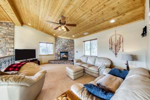 a living room with couches and a ceiling fan at Brian Head 'View-Topia' w/ Mtn Views & King Suite in Brian Head