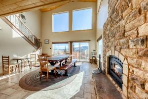 a dining room with a stone fireplace and a table and chairs at Brian Head 'View-Topia' w/ Mtn Views & King Suite in Brian Head