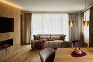 a living room with a couch and a table at Chalet Vanzi in San Martino in Badia