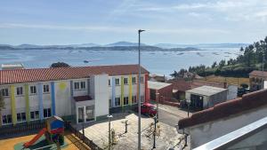 a view of a town with a large body of water at Villa HEGODEI in A Pobra do Caramiñal