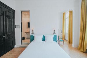 a bedroom with a white bed and a black door at Paulus41 in Antwerp