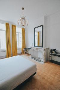 a bedroom with a bed and a fireplace and a mirror at Paulus41 in Antwerp