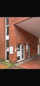 a brick building with a window with a bench in it at GW Apartment 1 in Meppen