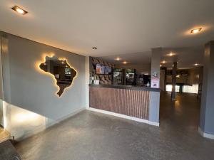 a bar with a sign on the wall of a store at Hotel Paddock in São Paulo