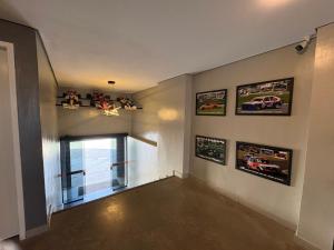 a room with a window and pictures on the wall at Hotel Paddock in São Paulo