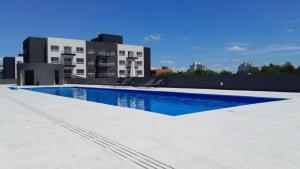 a large swimming pool on top of a building at Sunny Stay Ezeiza in Ezeiza